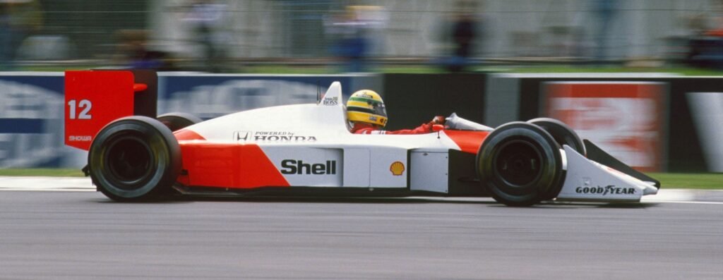 This image shows Ayrton Senna driving his McLaren MP4/4 Formula 1 car