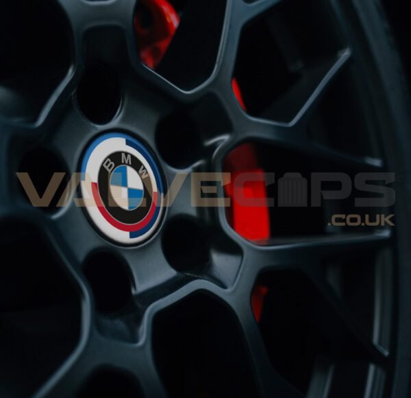 This image shows a BMW 50 Jahre wheel badge fitted to a black alloy wheel
